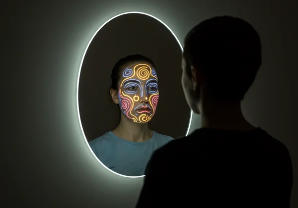 Person gazing at a mirror, reflecting emotional landscape.
